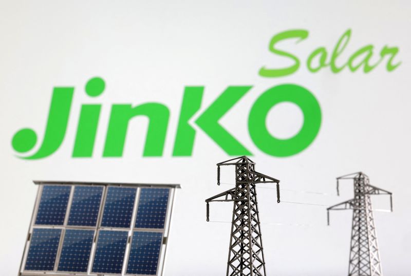 Miniatures of solar panel and electric pole are seen in front of JinkoSolar logo in this illustration taken January 17, 2023. REUTERS/Dado Ruvic/Illustration