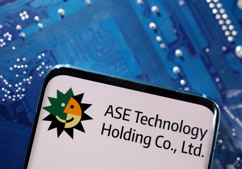 FILE PHOTO: A smartphone with a displayed ASE Technology Holding logo is placed on a computer motherboard in this illustration taken March 6, 2023. REUTERS/Dado Ruvic/Illustration/File Photo