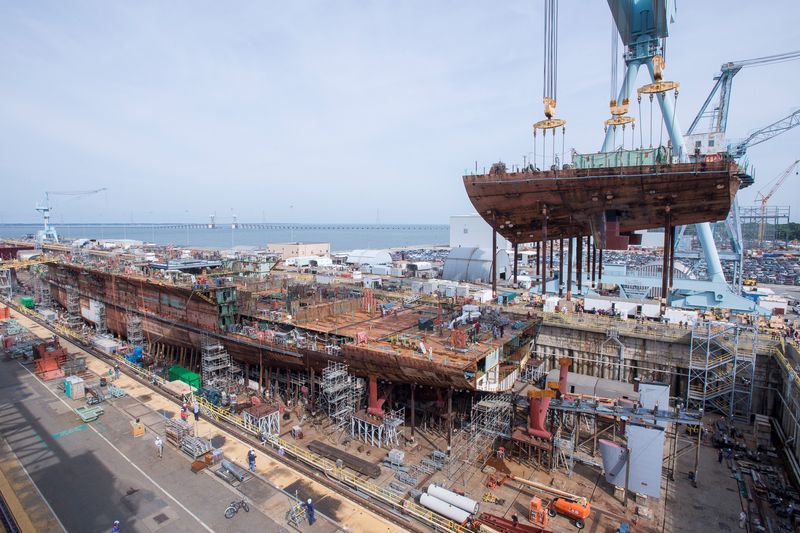 FILE PHOTO: A crane moves the lower stern into place on a nuclear-powered aircraft carrier at Huntington Ingalls Shipbuilding in Newport News, Virginia, U.S., in this June 22, 2017 handout photo. U.S. Navy/Handout via REUTERS/File photo