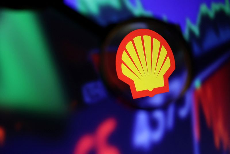 Shell logo and stock graph are seen through a magnifier displayed in this illustration taken September 4, 2022. REUTERS/Dado Ruvic/Illustration