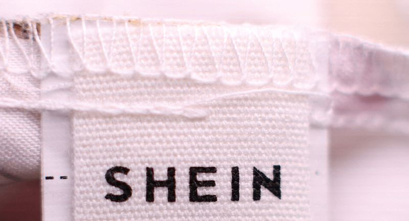 FILE PHOTO: A Shein logo is pictured on the label on a childs top in Manchester, Britain, December 11, 2024. REUTERS/Phil Noble/File Photo