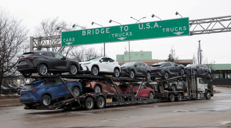 FILE PHOTO: A car hauler drives towards the Ambassador Bridge to Detroit, Michigan from Windsor, Ontario, Canada,  March  4, 2025.     REUTERS/Rebecca Cook/File Photo/File Photo