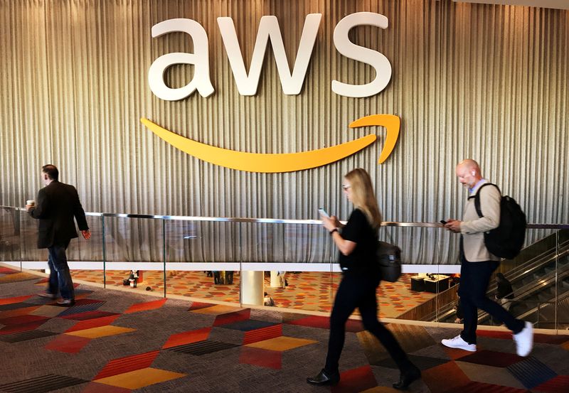FILE PHOTO: Attendees at Amazon.com Inc annual cloud computing conference walk past the Amazon Web Services logo in Las Vegas, Nevada, U.S., November 30, 2017.    REUTERS/Salvador Rodriguez/File Photo