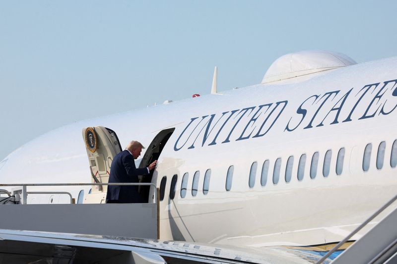 FILE PHOTO: U.S. President Donald Trump boards Air Force One for travel back to Washington, D.C., at Palm Beach International Airport, in West Palm Beach, Florida, U.S. May 4, 2025. REUTERS/Leah Millis/File Photo