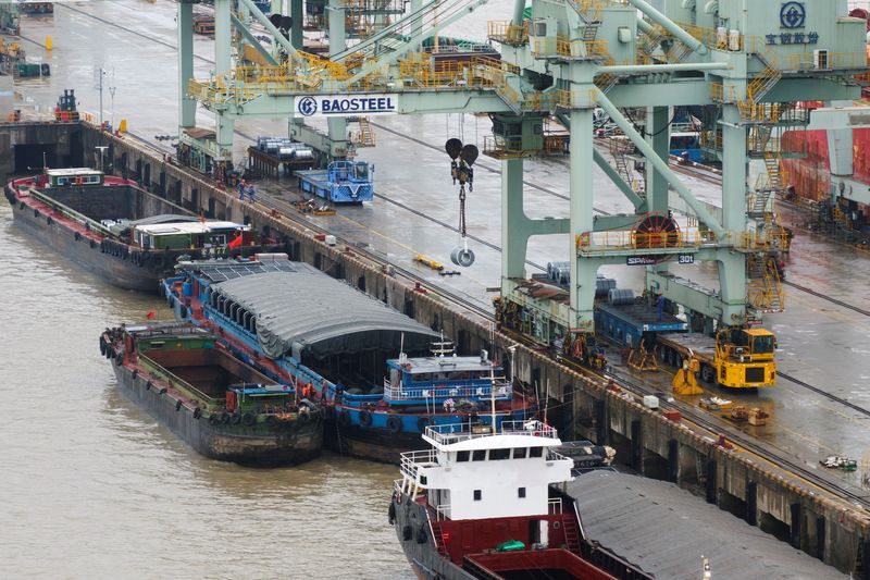 FILE PHOTO: A crane transports steel coil at a port under Baosteel Group, in Baoshan district of Shanghai, China March 13, 2025. China Daily via REUTERS/File Photo