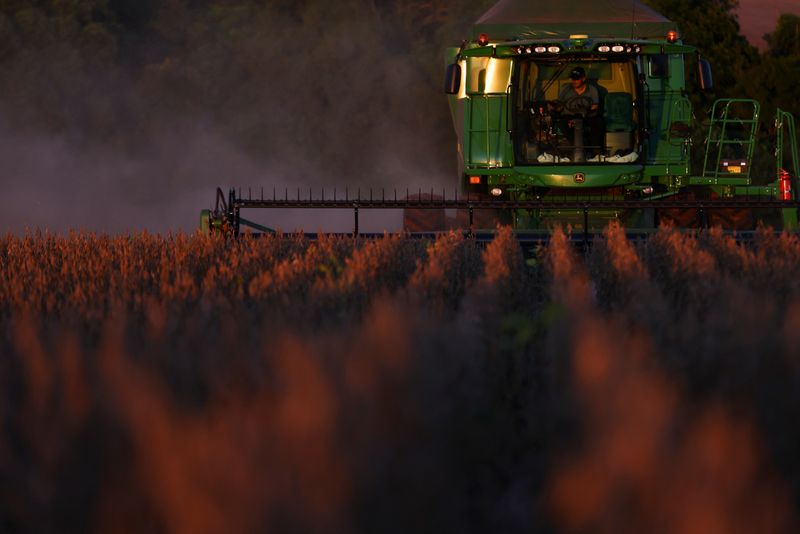 FILE PHOTO: A farm worker operates a combine harvester during the soybean harvest season in Brazil's southernmost state, on a farm in Nao Me Toque, Rio Grande do Sul state, Brazil, April 4, 2025. REUTERS/Diego Vara/File photo