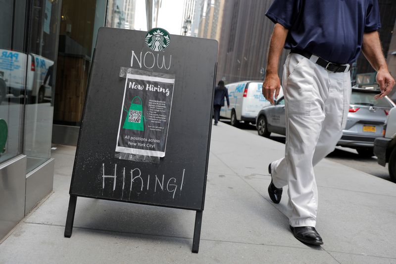 FILE PHOTO: A sign advertising job openings is seen outside of a Starbucks in Manhattan, New York City, New York, U.S., May 26, 2021. REUTERS/Andrew Kelly/File photo