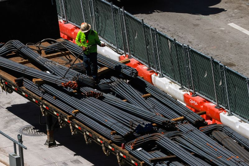 FILE PHOTO: Workers install steel rods at a construction site in Miami, Florida, U.S., March 11, 2025. REUTERS/Giorgio Viera/File photo