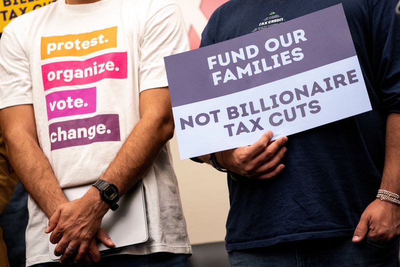 Demonstrators hold signs during a press conference to discuss cuts to Medicaid, the Supplemental Nutrition Assistance Program (SNAP) and the Child Tax Credit, on Capitol Hill in Washington, D.C., U.S., May 13, 2025. REUTERS/Nathan Howard