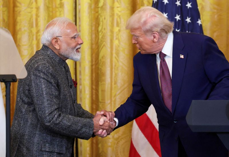 FILE PHOTO: U.S. President Donald Trump and Indian Prime Minister Narendra Modi shake hands as they attend a joint press conference at the White House in Washington, D.C., U.S., February 13, 2025. REUTERS/Kevin Lamarque/File Photo
