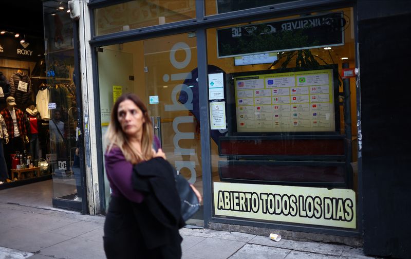 A pedestrian walks past a currency exchange office, in downtown Buenos Aires, Argentina May 8, 2025. REUTERS/Agustin Marcarian