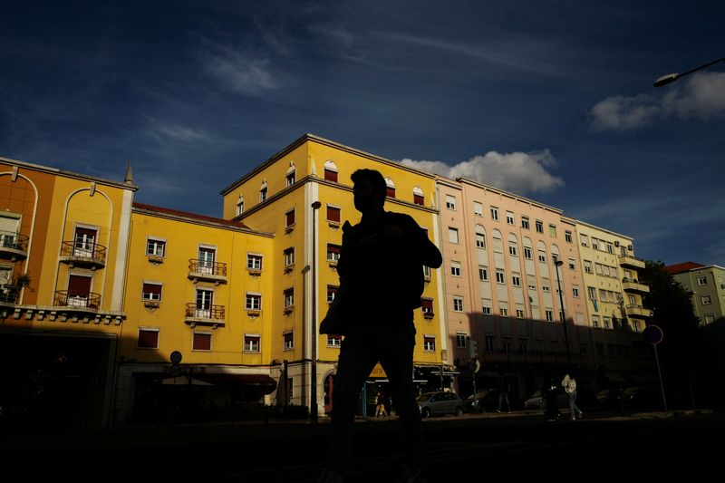 A man walks in silhouette in Lisbon