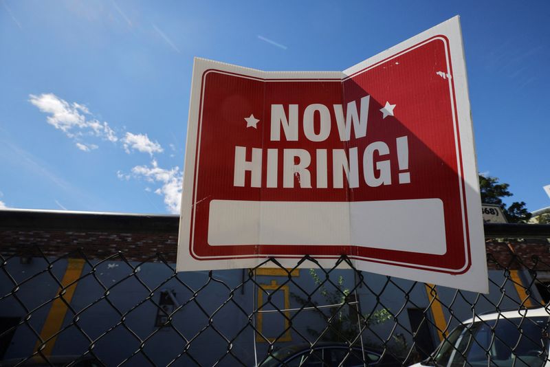 A “now hiring” sign is displayed in Somerville