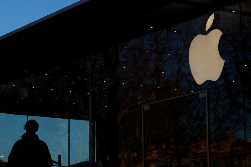A man walks past an Apple logo outside an Apple store in Aix-en Provence, France, January 15, 2025. REUTERS/Manon Cruz/File Photo