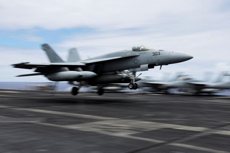 FILE PHOTO: A F-18 jet lands on the runway of the USS Carl Vinson aircraft carrier during the Rim of the Pacific (RIMPAC) military exercises about 100 miles south of Oahu, Hawaii, U.S. July 19, 2024.  REUTERS/Marco Garcia/File Photo