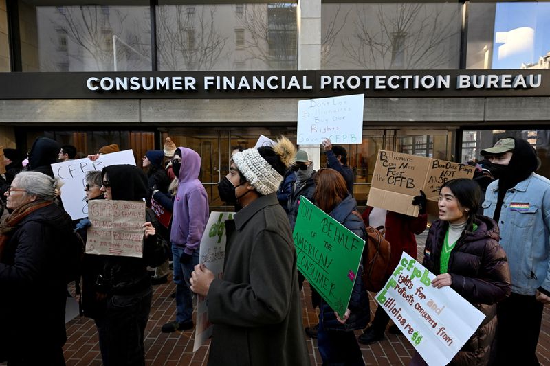 FILE PHOTO: Supporters of the Consumer Financial Protection Bureau (CFPB) rally after Acting Consumer Financial Protection Bureau (CFPB) Director Russell Vought told all of the agency's staff to stay away from the office and do no work, outside the CFPB in Washington, U.S., February 10, 2025. REUTERS/Craig Hudson/File Photo