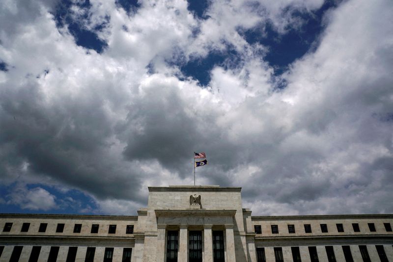 FILE PHOTO: Flags fly over the Federal Reserve Headquarters on a windy day in Washington, U.S., May 26, 2017. REUTERS/Kevin Lamarque/File Photo