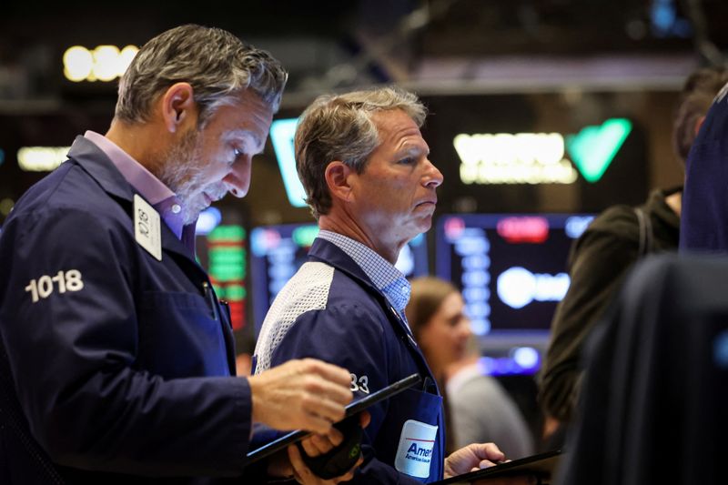 Traders work on the floor at the New York Stock Exchange (NYSE) in New York City, U.S., March 27, 2025.  REUTERS/Brendan McDermid