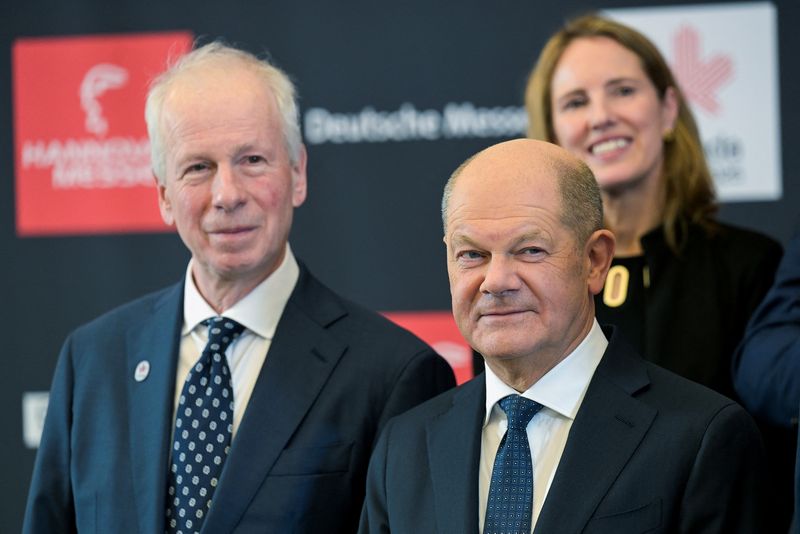 German outgoing Chancellor Olaf Scholz and Canadian Special Envoy for the European Union and Europe Stephane Dion pose for a group photo, at the Hannover Messe, one of the world's largest industrial trade fairs with this year's partner country being Canada, which, like the European Union, is similarly affected by the new U.S. tariffs, in Hanover, Germany, March 30, 2025.  REUTERS/Fabian Bimmer