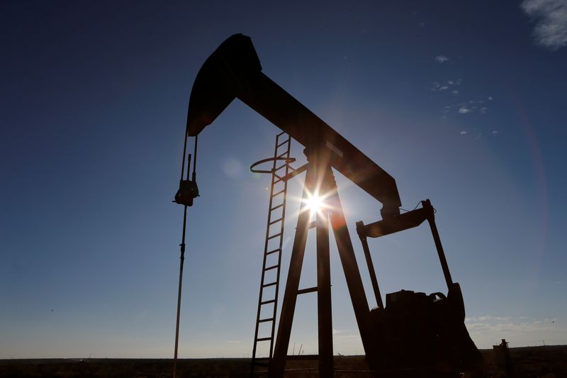 The sun is seen behind a crude oil pump jack in the Permian Basin in Loving County, Texas, U.S., November 22, 2019. Picture taken November 22, 2019.  REUTERS/Angus Mordant/File Photo