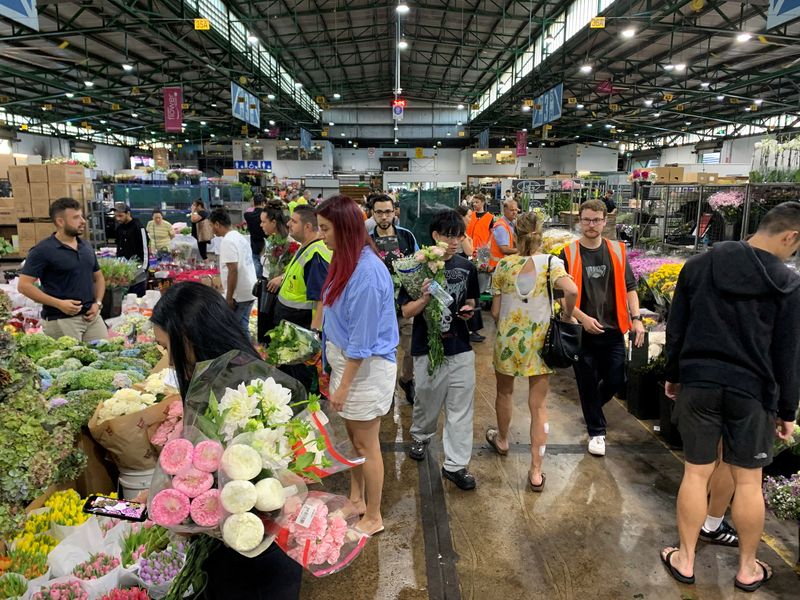 FILE PHOTO: Customers shop at the Sydney Flower Market in preparation for Valentine's Day in Sydney, Australia, February 13, 2025. REUTERS/Stefica Nicol Bikes/File Photo