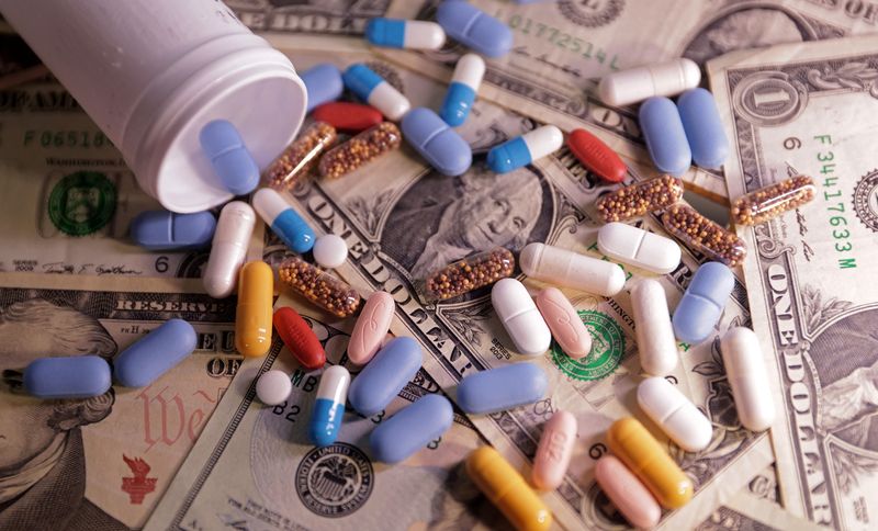 U.S. dollar banknotes and medicines are seen in this illustration taken, June 27, 2024. REUTERS/Dado Ruvic/Illustration