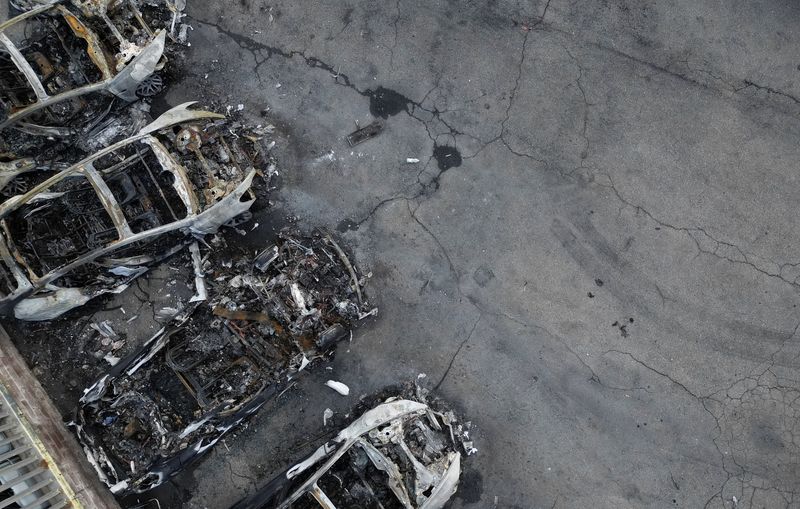 A drone view shows charred Tesla vehicles following a fire at a Tesla dealership that destroyed vehicles, in Rome, Italy, March 31, 2025. REUTERS/Yara Nardi/File Photo