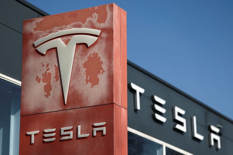 The logo of Tesla is pictured at a dealership in Saint-Herblain near Nantes, France, March 27, 2025. REUTERS/Stephane Mahe/File Photo