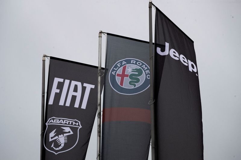 FILE PHOTO: Banners showing logos of Fiat, Jeep, Abarth and Alfa Romeo are hung outside a car dealership in Milan, Italy, November 21, 2024. REUTERS/Alessandro Garofalo / File Photo