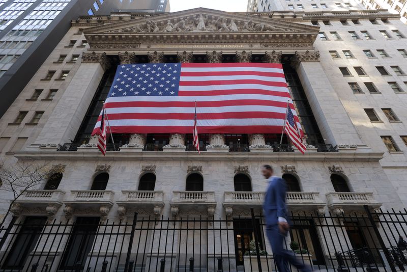 FILE PHOTO: U.S. flags hang on the building of the New York Stock Exchange (NYSE), in New York City, U.S., November 6, 2024. REUTERS/Andrew Kelly/File Photo