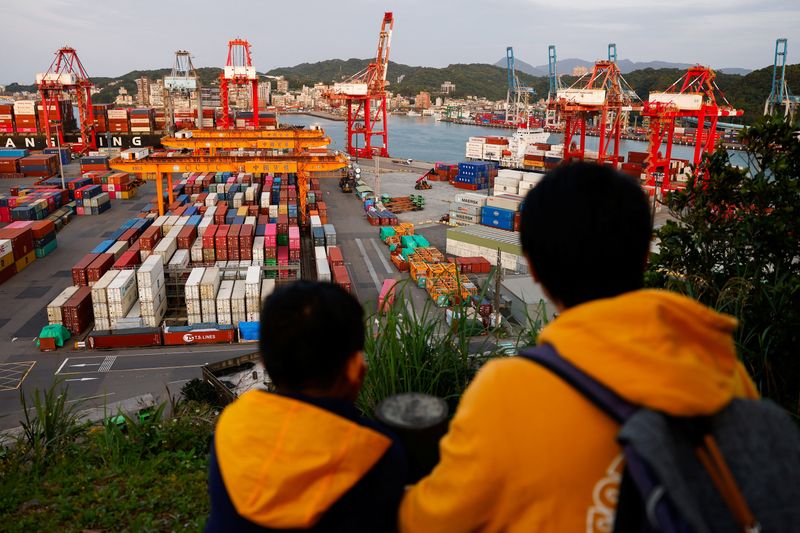 FILE PHOTO: Kids view the area from a lookout point over cranes and containers at the Port of Keelung, Taiwan April 3, 2025. REUTERS/Ann Wang/File Photo
