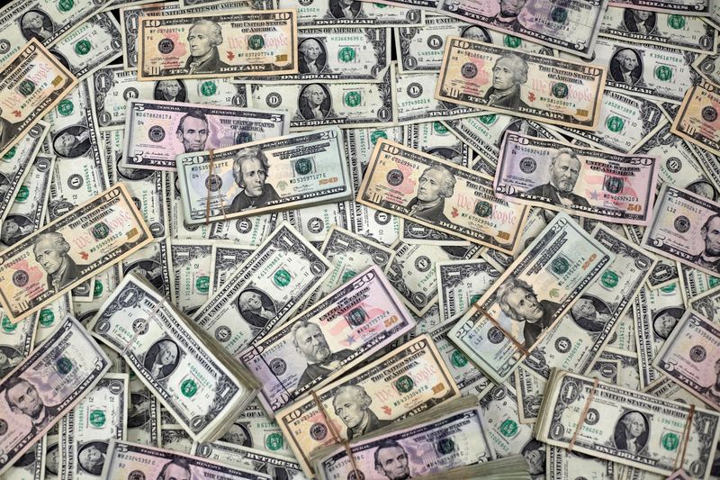 FILE PHOTO: U.S. dollar banknotes are seen in this photo illustration taken February 12, 2018. REUTERS/Jose Luis Gonzalez/Illustration/File Photo