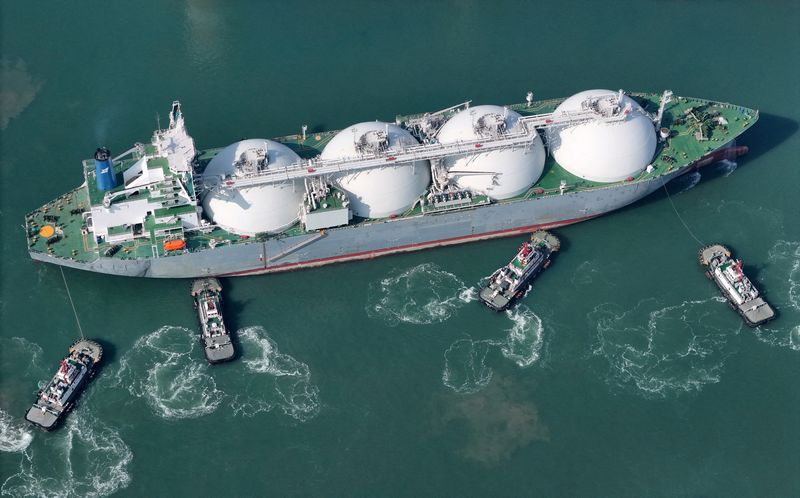 FILE PHOTO: A drone view shows tugboats assisting a liquified natural gas (LNG) tanker to dock at a port in Yantai, Shandong province, China February 14, 2025. cnsphoto via REUTERS/File Photo