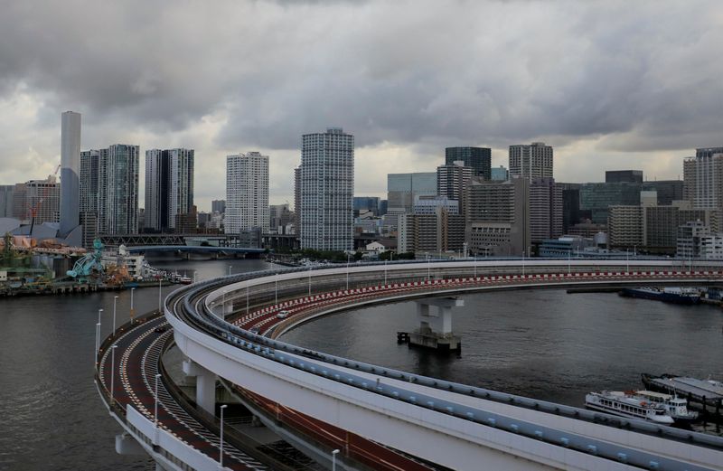 FILE PHOTO: A view of the Tokyo skyline is seen through the window of a special bus transporting journalists to the media hotel during the Tokyo 2020 Olympic Games in Tokyo, Japan, August 2, 2021. REUTERS/Amr Abdallah Dalsh/File Photo