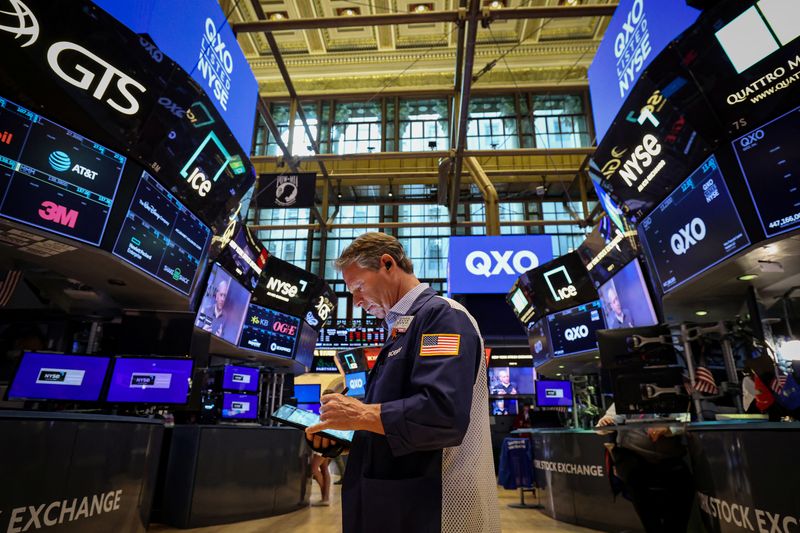 FILE PHOTO: A trader works on the floor at the New York Stock Exchange (NYSE) in New York City, U.S., April 30, 2025.  REUTERS/Brendan McDermid/File Photo