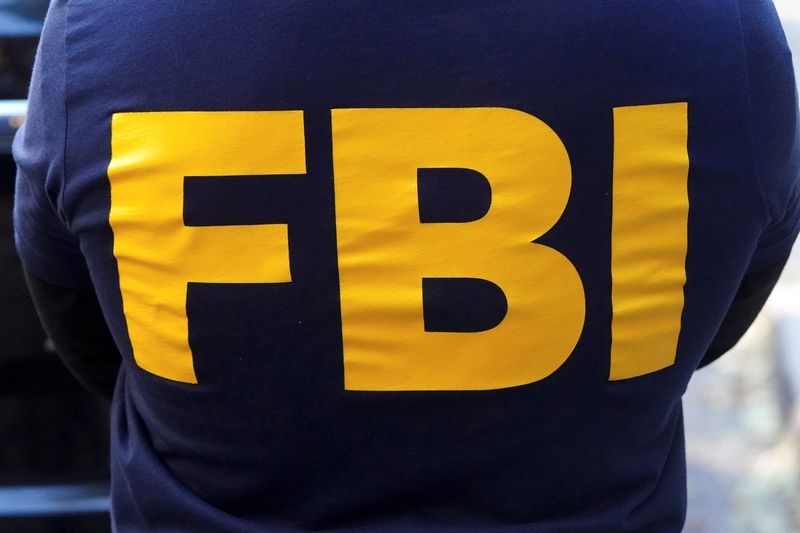FILE PHOTO: An FBI logo is pictured on an agent's shirt in the Manhattan borough of New York City, New York, U.S. October 19, 2021. REUTERS/Carlo Allegri/File Photo