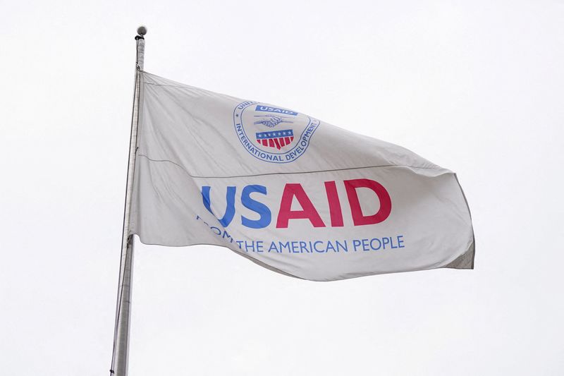 A USAID flag flutters outside, as the USAID building sits closed to employees after a memo was issued advising agency personnel to work remotely, in Washington, D.C., U.S., February 3, 2025. REUTERS/Kent Nishimura