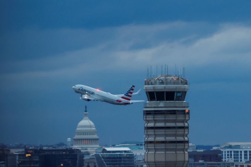 FILE PHOTO: An American Airlines plane departs the Ronald Reagan Washington National, in the aftermath of the collision of American Eagle flight 5342 and a Black Hawk helicopter that crashed into the Potomac River, with the Capitol dome in the background, as seen from Virginia, U.S., February 1, 2025. REUTERS/Eduardo Munoz/File Photo