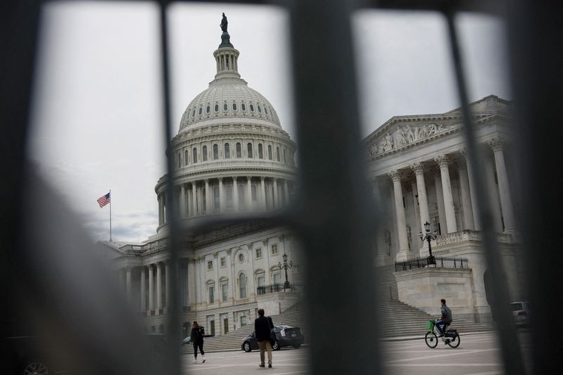 FILE PHOTO: The U.S. Capitol building viewed through the bars of standard barricades in Washington, U.S., April 4, 2025. REUTERS/Leah Millis/File Photo