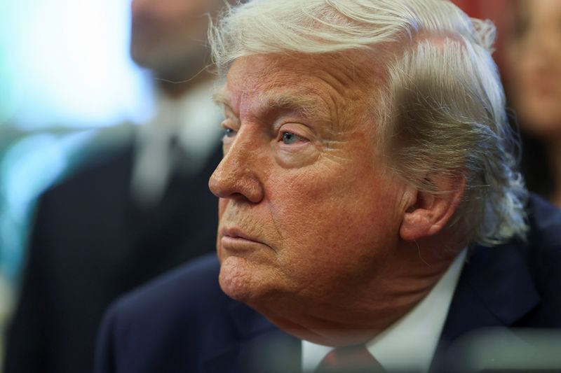 FILE PHOTO: U.S. President Donald Trump looks on, as he signs executive orders in the Oval Office at the White House in Washington, D.C., U.S., April 23, 2025. REUTERS/Leah Millis/File Photo
