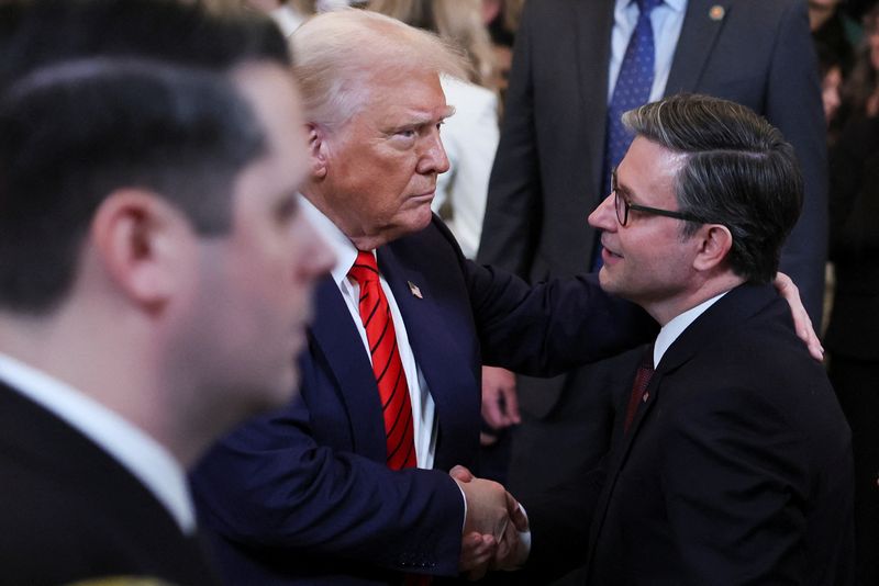 FILE PHOTO: U.S. President Donald Trump shakes hands with Speaker of the House Mike Johnson in the East Room at the White House in Washington, U.S., February 5, 2025. REUTERS/Leah Millis/File Photo