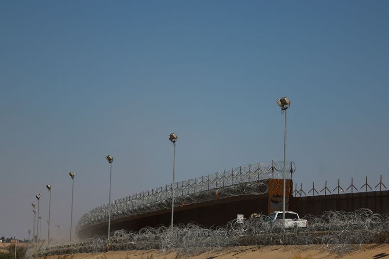 A U.S. Border Patrol vehicle conducts surveillance near a section of the U.S.-Mexico border wall, as seen from Ciudad Juarez, Mexico May 5, 2025. REUTERS/Jose Luis Gonzalez/File Photo