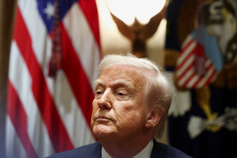 U.S. President Donald Trump looks on on the day of a meeting with U.S. ambassadors at the White House in Washington, D.C., U.S., March 25, 2025. REUTERS/Evelyn Hockstein