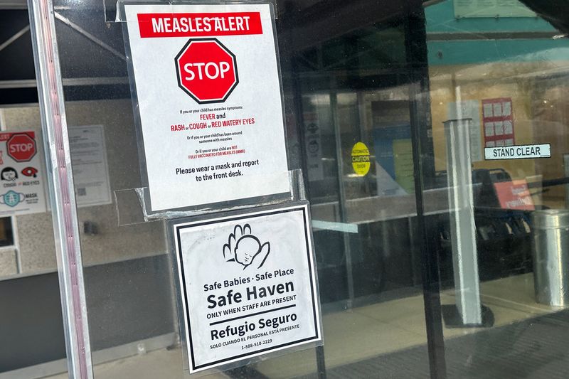 FILE PHOTO: A measles alert sign hangs outside the entrance to the Cohen Children's Medical Center, where the state health department confirmed that a baby tested positive and that there is a possibility of exposure to others at the facility, in New Hyde Park, New York, U.S., March 14, 2025.  REUTERS/Shannon Stapleton/File Photo