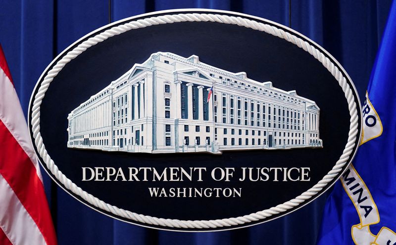 FILE PHOTO: A U.S. Justice Department logo or seal showing Justice Department headquarters, known as "Main Justice," is seen behind the podium in the Department's headquarters briefing room before a news conference in Washington, January 24, 2023.  REUTERS/Kevin Lamarque//File Photo