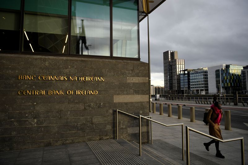 Woman walks past the Central Bank of Ireland in Dublin