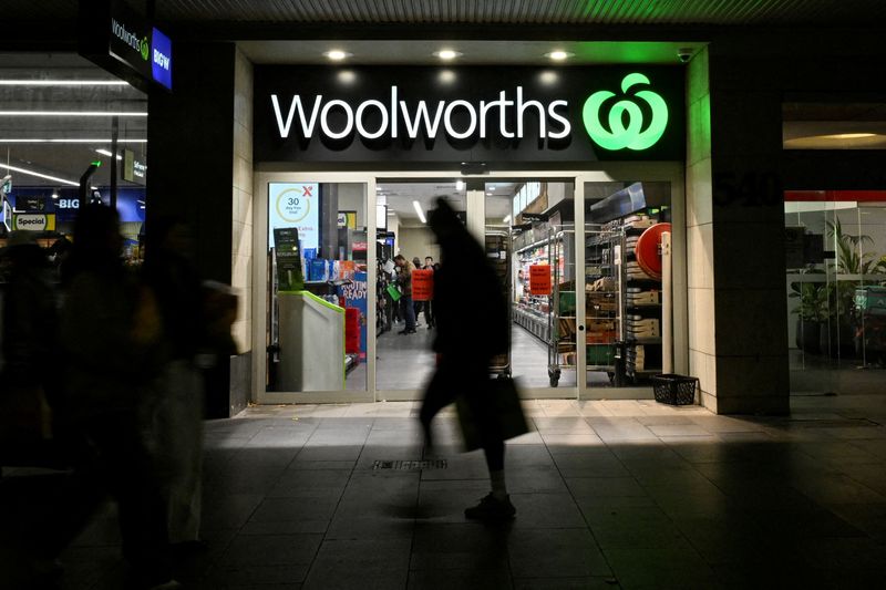 FILE PHOTO: A person walks past a Woolworths supermarket in the Sydney Central Business District in Sydney, Australia, May 14, 2024. REUTERS/Jaimi Joy//File Photo