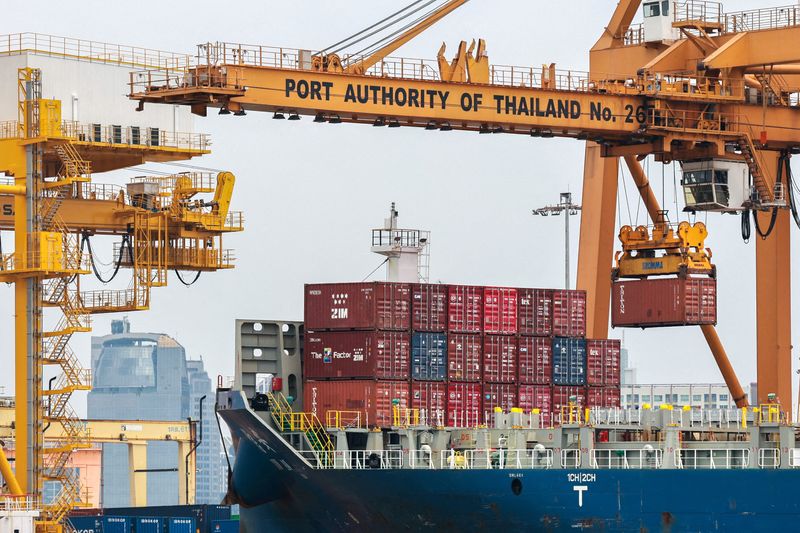 FILE PHOTO: Cargo ships are loaded with containers as it is docked at the port of Bangkok, in Bangkok, Thailand, April 3, 2025. Thailand, with a tariff rate of 37 per cent imposed by U.S. President Donald Trump, is one of six countries in the Southeast Asian region slapped with much higher-than-expected tariffs by the U.S. REUTERS/Athit Perawongmetha/File Photo