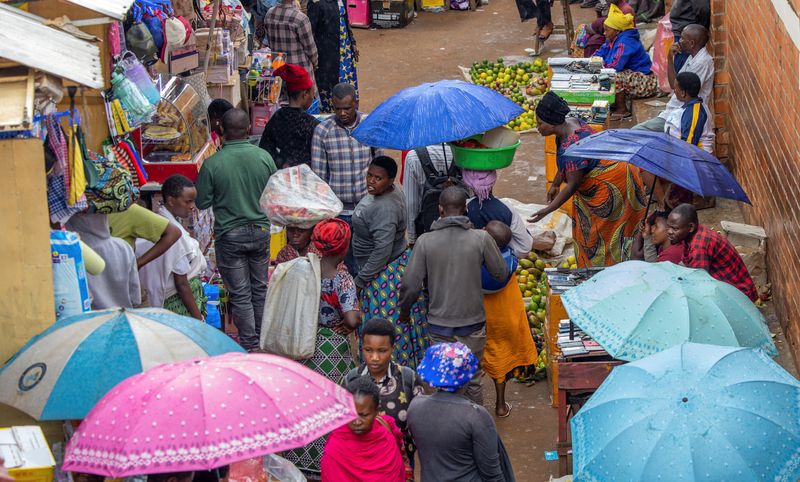 FILE PHOTO: Residents walk at an open air grocery market in the outskirts Kigali, Rwanda, April 26, 2024. REUTERS/Jean Bizimana/File photo