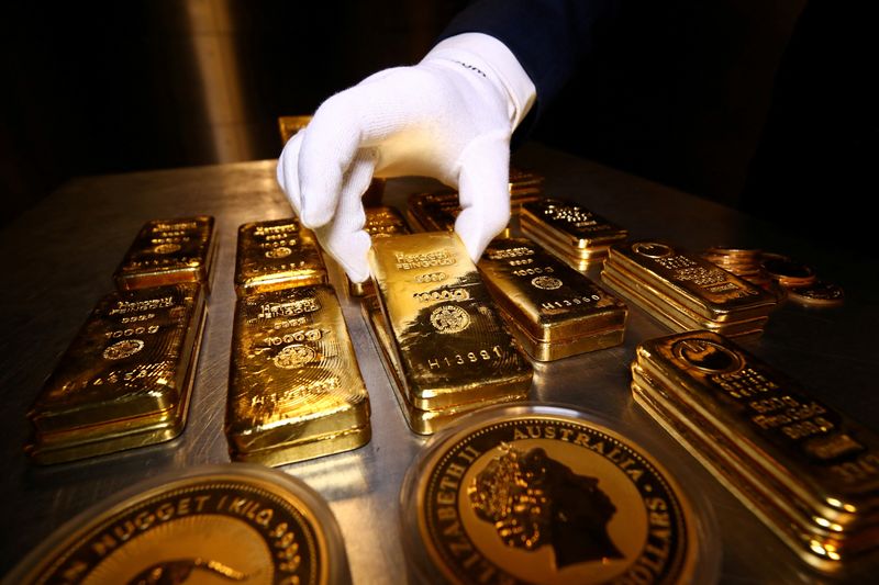 FILE PHOTO: Gold bars and coins are stacked in the safe deposit boxes room of the Pro Aurum gold house in Munich, Germany,  August 14, 2019. REUTERS/Michael Dalder/File Photo
